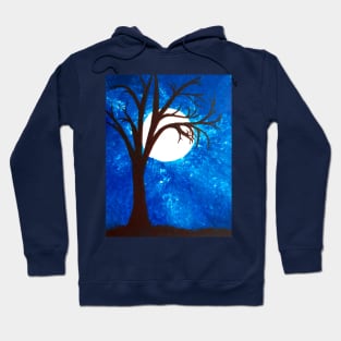 A moonlit blue nightsky in winter bare tree spooky eerie Hoodie